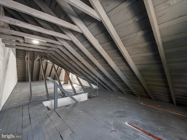 unfinished attic featuring an upstairs landing