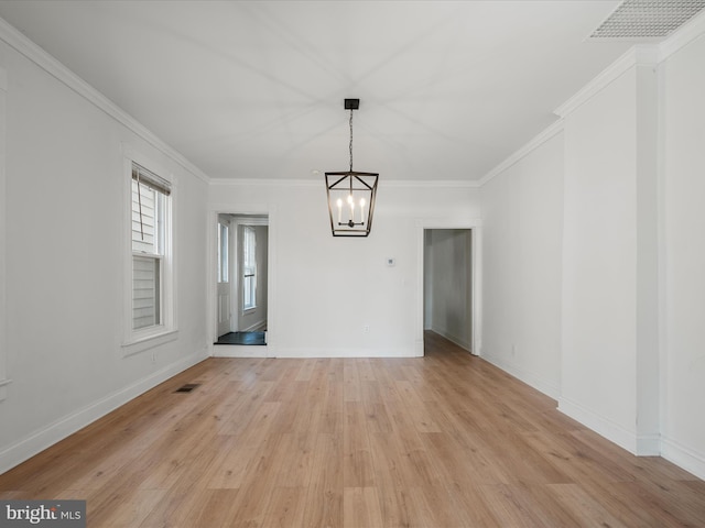 unfurnished dining area with visible vents, baseboards, light wood-style floors, and ornamental molding