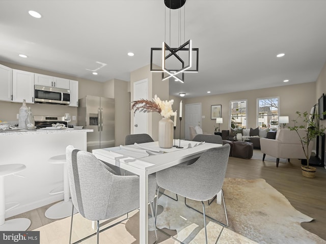 dining space featuring recessed lighting and light wood-type flooring