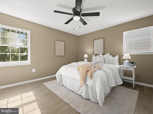 bedroom featuring a ceiling fan, wood finished floors, and baseboards