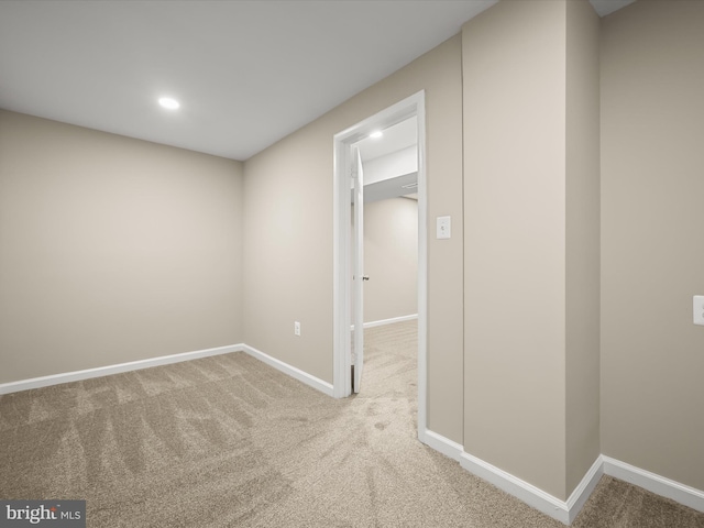 carpeted spare room featuring recessed lighting and baseboards