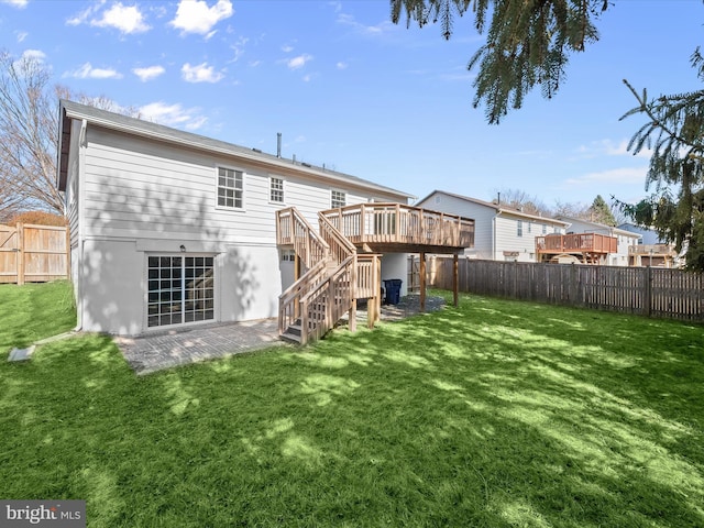 back of house with a fenced backyard, a deck, stairs, and a yard