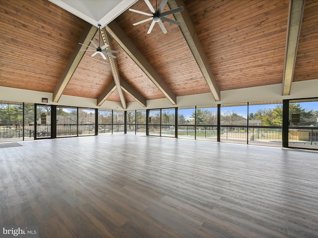 interior space featuring a ceiling fan, wooden ceiling, vaulted ceiling with beams, and a healthy amount of sunlight