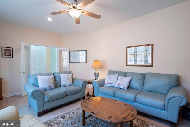 living room with recessed lighting, ceiling fan, light wood-style flooring, and baseboards