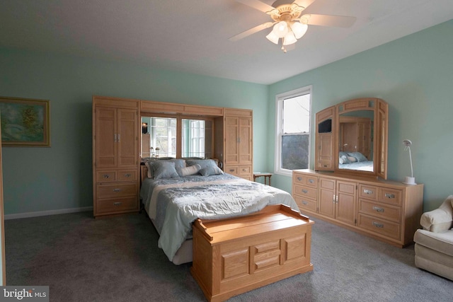 carpeted bedroom featuring ceiling fan and baseboards