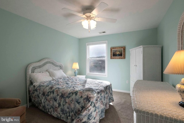 carpeted bedroom with a ceiling fan, visible vents, and baseboards