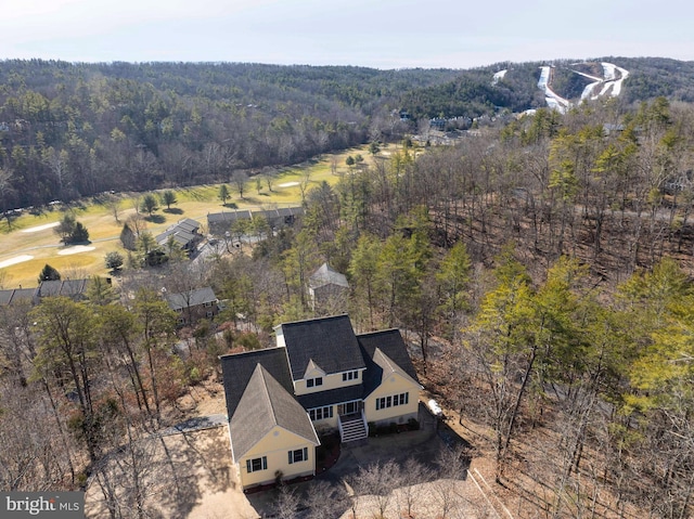 drone / aerial view featuring a view of trees