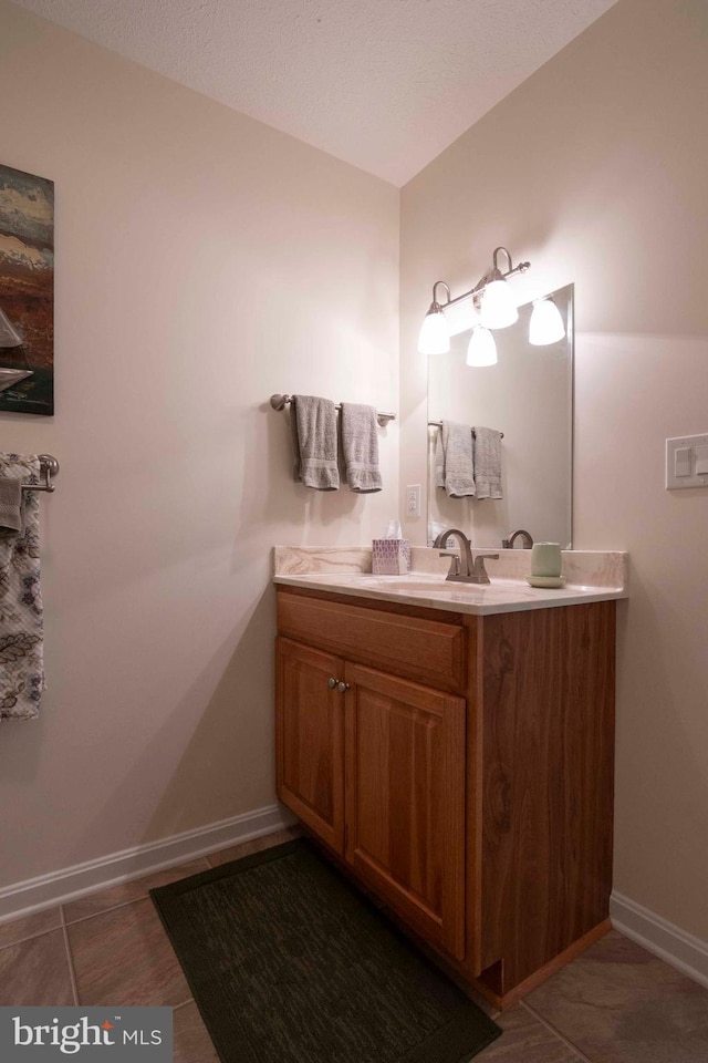 bathroom featuring vanity and baseboards