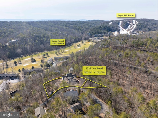 birds eye view of property featuring a forest view