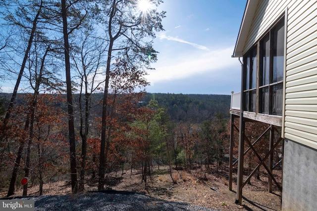 view of yard featuring a forest view