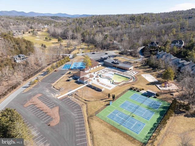 aerial view featuring a forest view and a mountain view