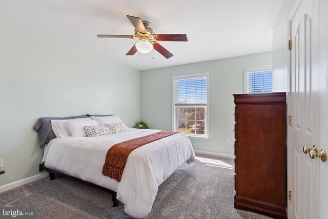 bedroom featuring a ceiling fan, carpet, and baseboards