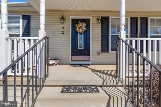 view of exterior entry with covered porch