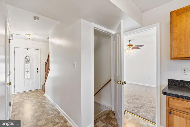 corridor with stairway and baseboards