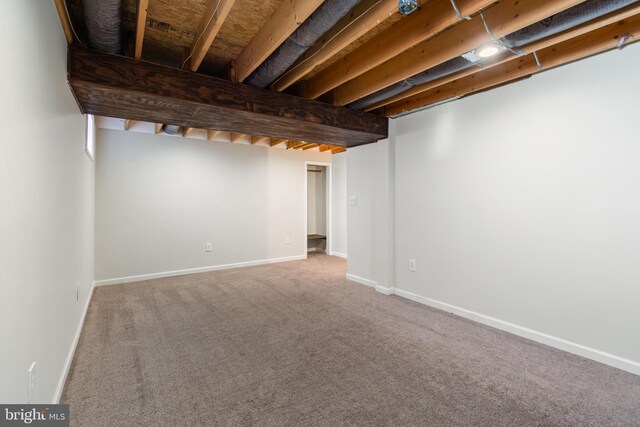 finished basement featuring baseboards and carpet floors