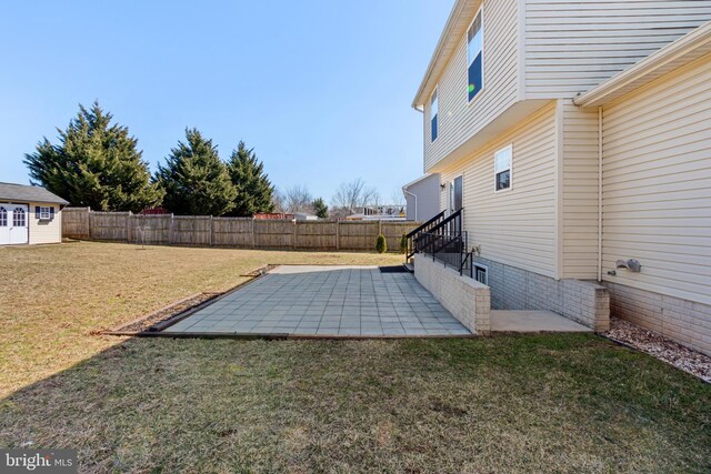 view of yard featuring a patio area and a fenced backyard