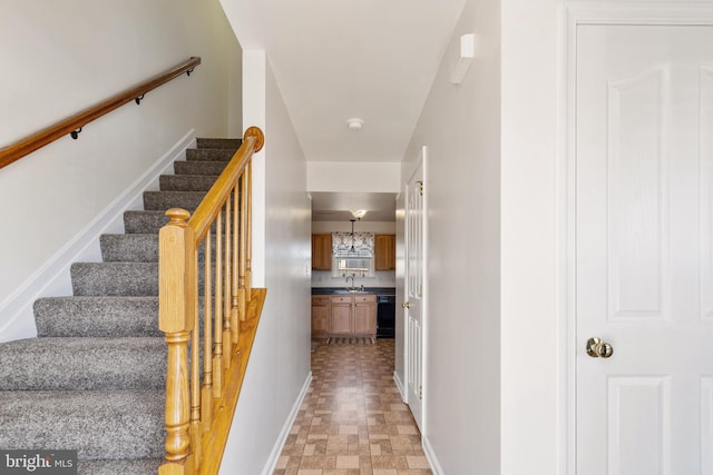 stairway featuring baseboards