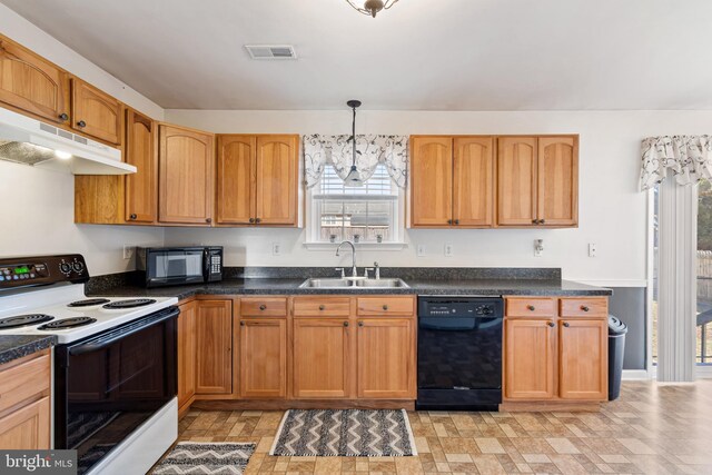 kitchen featuring visible vents, black appliances, a sink, under cabinet range hood, and dark countertops