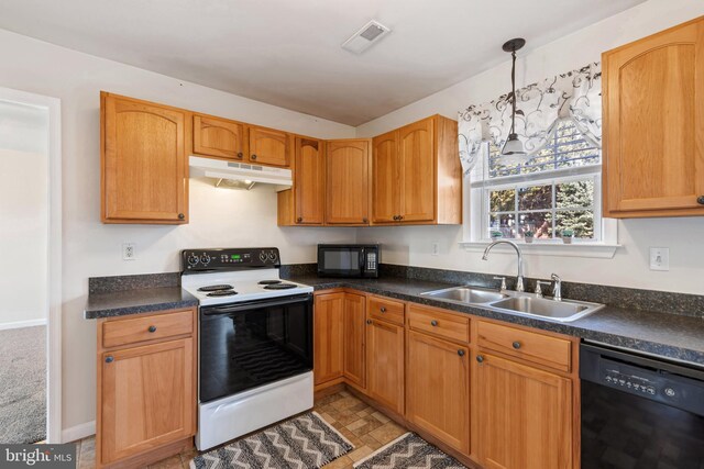 kitchen featuring visible vents, a sink, black appliances, under cabinet range hood, and dark countertops