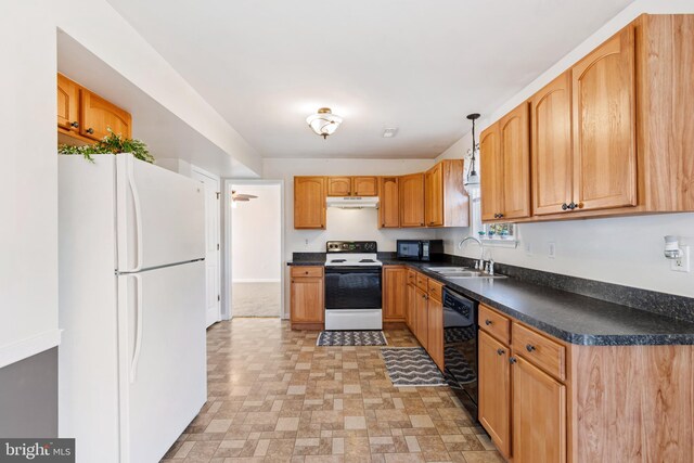 kitchen with dark countertops, under cabinet range hood, decorative light fixtures, black appliances, and a sink