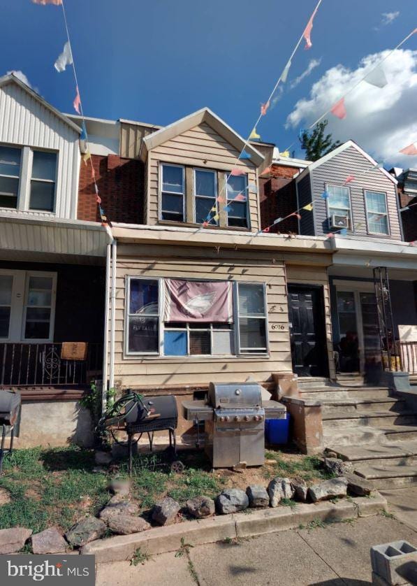 back of property featuring covered porch