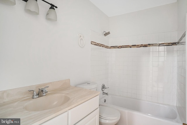 bathroom with bathtub / shower combination, vanity, and toilet