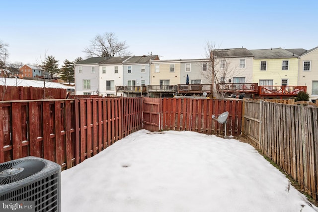 view of yard with a residential view, a fenced backyard, and cooling unit