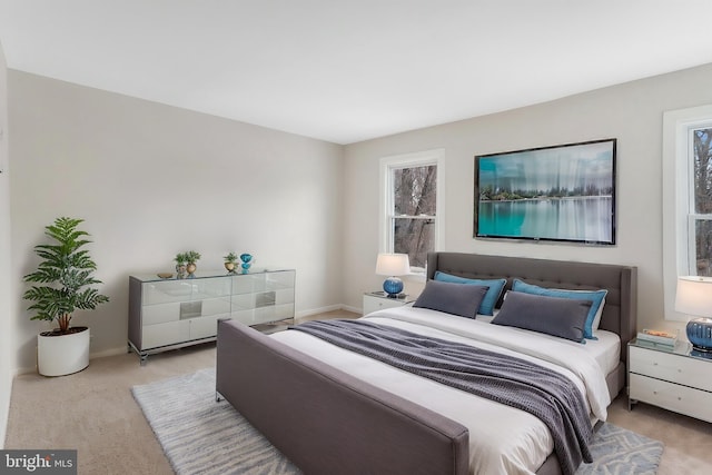 carpeted bedroom featuring baseboards