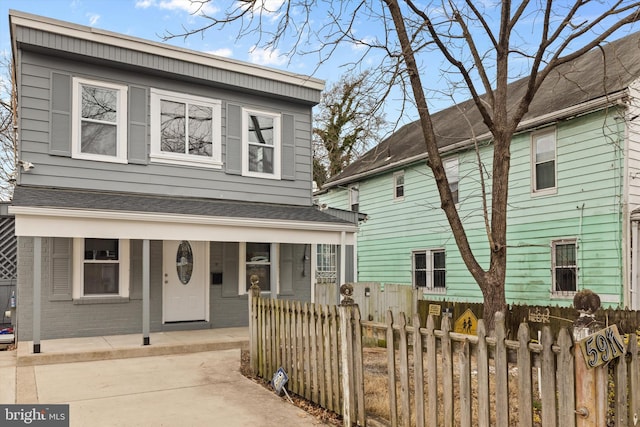 5917 Crown St, Capitol Heights, MD 20743 - view of front facade with covered porch, a fenced front yard, roof with shingles, and brick siding