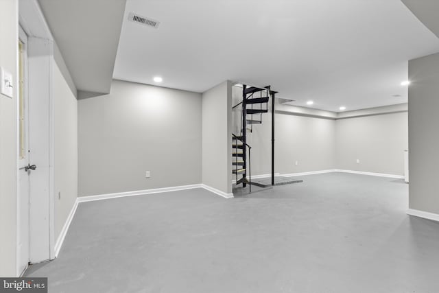 finished below grade area featuring baseboards, stairway, visible vents, and recessed lighting