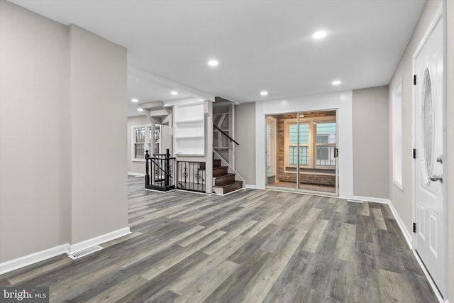 interior space featuring baseboards, wood finished floors, visible vents, and recessed lighting