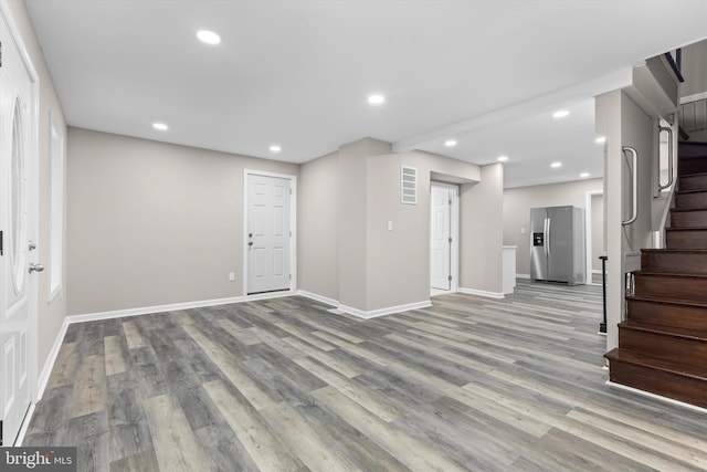 entrance foyer with stairs, baseboards, wood finished floors, and recessed lighting