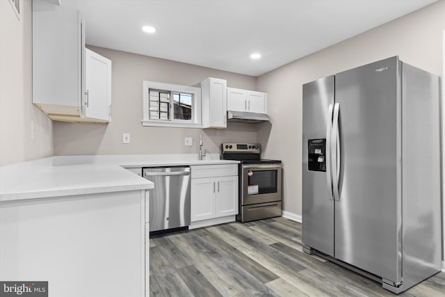 kitchen with stainless steel appliances, light wood-style floors, white cabinetry, and under cabinet range hood