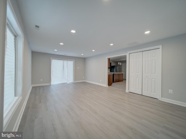 unfurnished living room with baseboards, recessed lighting, visible vents, and light wood-type flooring