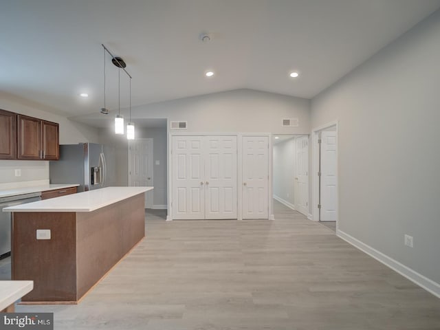 kitchen with stainless steel appliances, lofted ceiling, visible vents, and light countertops