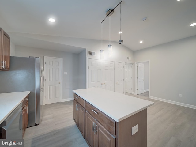 kitchen with visible vents, a center island, light countertops, light wood-style flooring, and appliances with stainless steel finishes