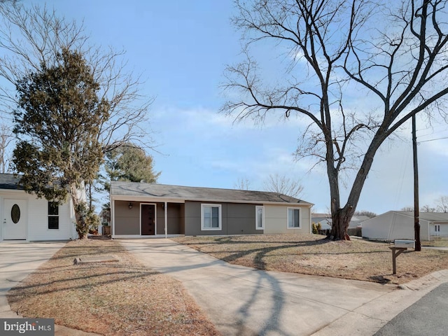 single story home featuring concrete driveway