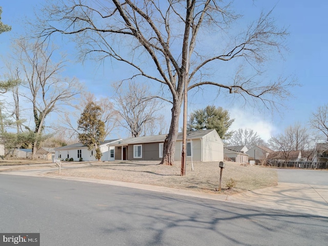 view of front of house featuring a residential view and driveway