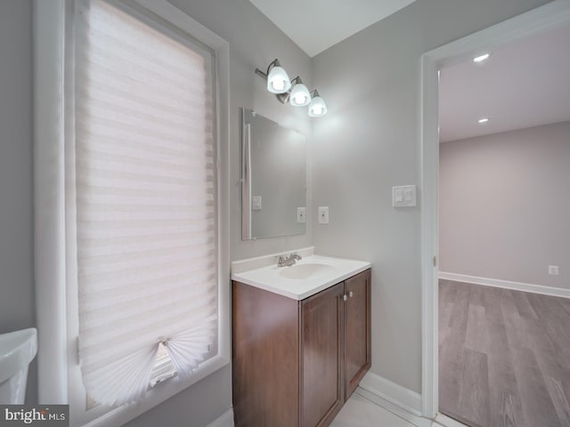 bathroom with vanity and baseboards