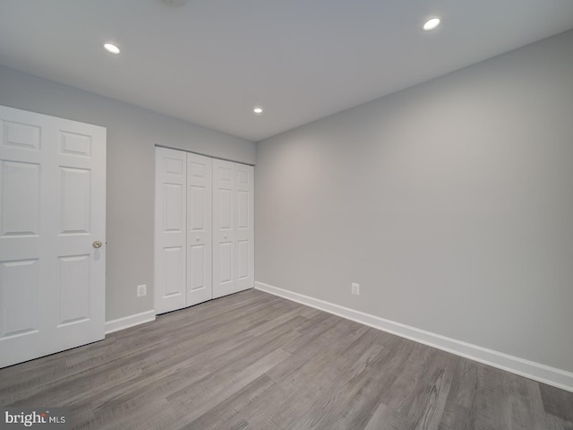 unfurnished bedroom featuring recessed lighting, baseboards, and wood finished floors