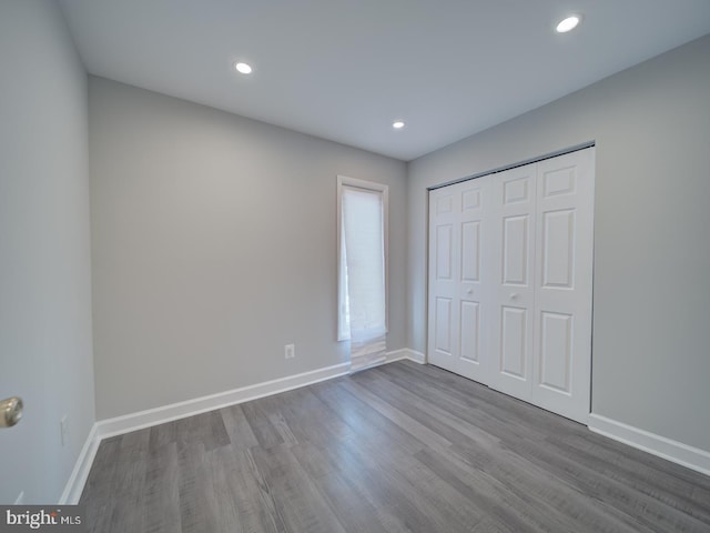 unfurnished bedroom featuring recessed lighting, baseboards, and wood finished floors