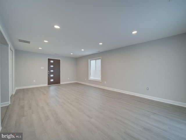 empty room with recessed lighting, visible vents, baseboards, and wood finished floors