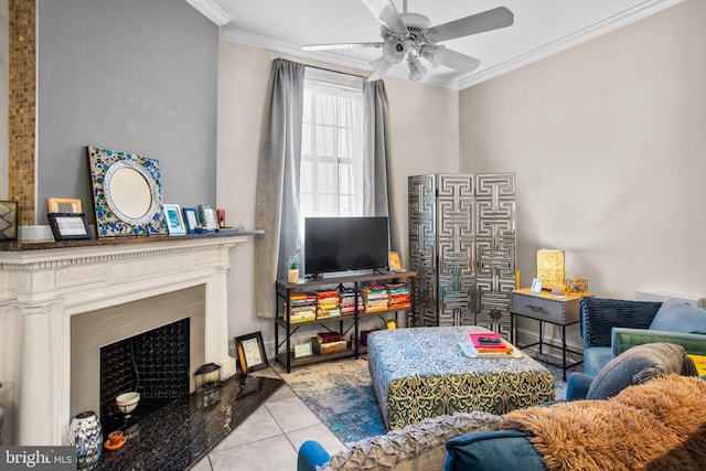 tiled living area featuring crown molding, a fireplace, and ceiling fan