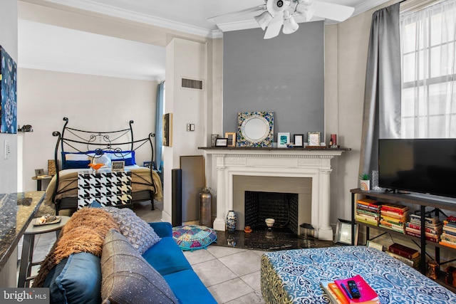 tiled living room featuring visible vents, a fireplace with flush hearth, ornamental molding, and a ceiling fan