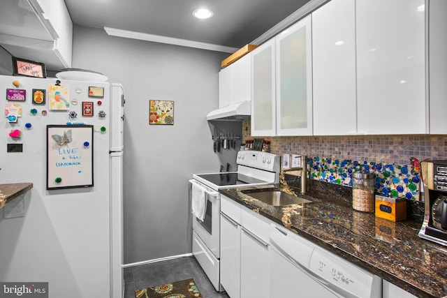 kitchen with under cabinet range hood, decorative backsplash, white appliances, white cabinetry, and a sink