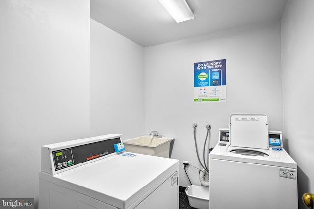 community laundry room featuring a sink and independent washer and dryer