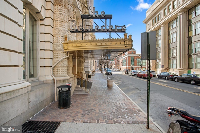 view of road featuring sidewalks, curbs, and street lighting