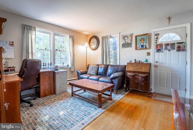 office featuring a baseboard heating unit and light wood-style floors