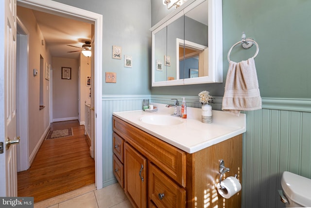 bathroom featuring a wainscoted wall, tile patterned flooring, ceiling fan, and vanity