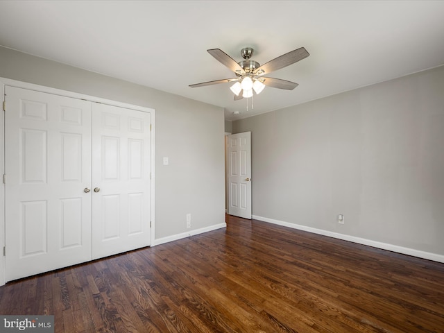 unfurnished bedroom with a closet, baseboards, ceiling fan, and wood finished floors